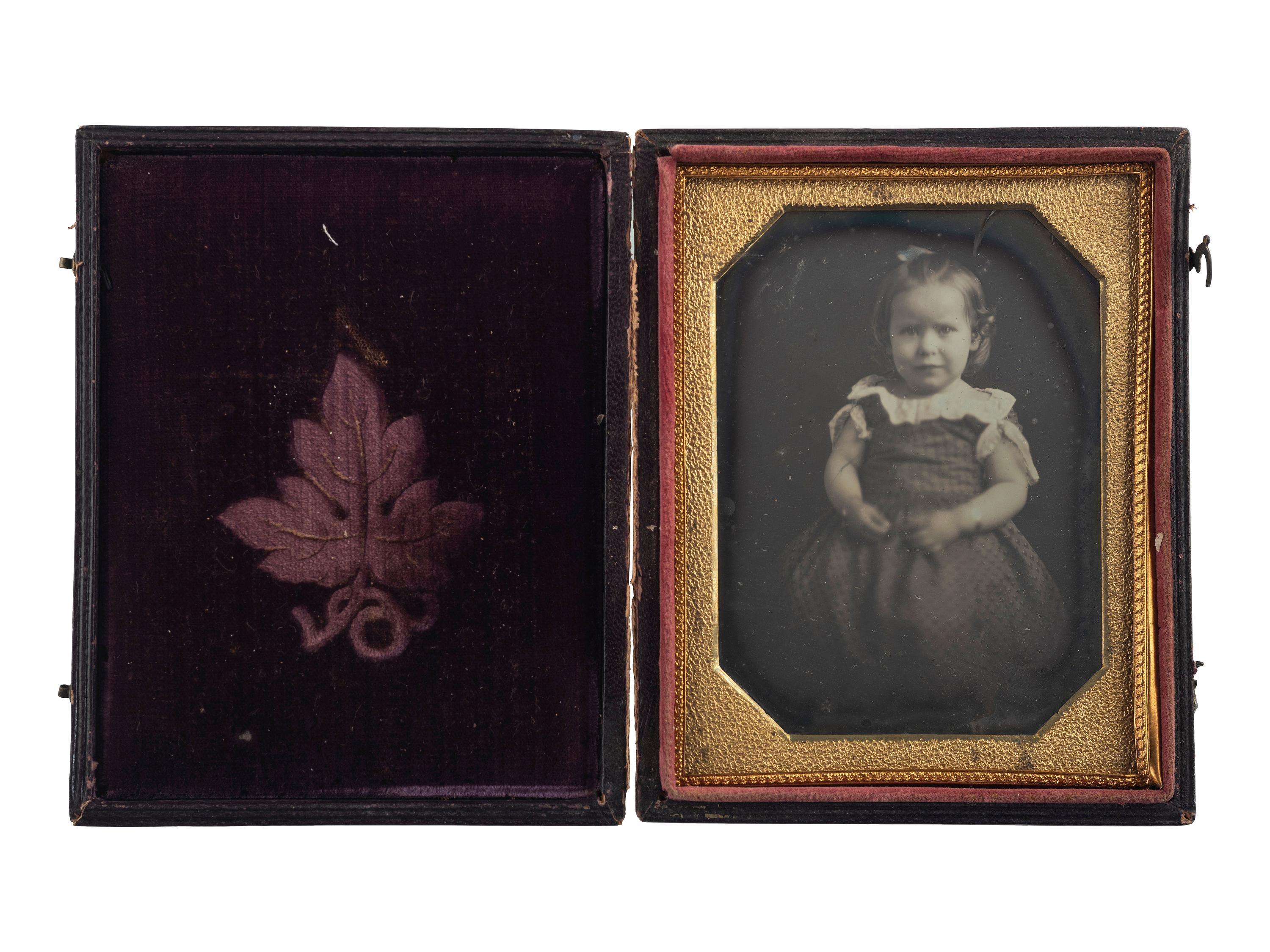 [EARLY PHOTOGRAPHY]. Quarter plate daguerreotype of sweet young girl with CDVs of men, women, and children from Woodstock Plantation. Baton Rouge, Louisiana.
