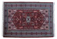 An Iranian Wool Rug 5 feet 10 inches x 4 feet 3 inches.