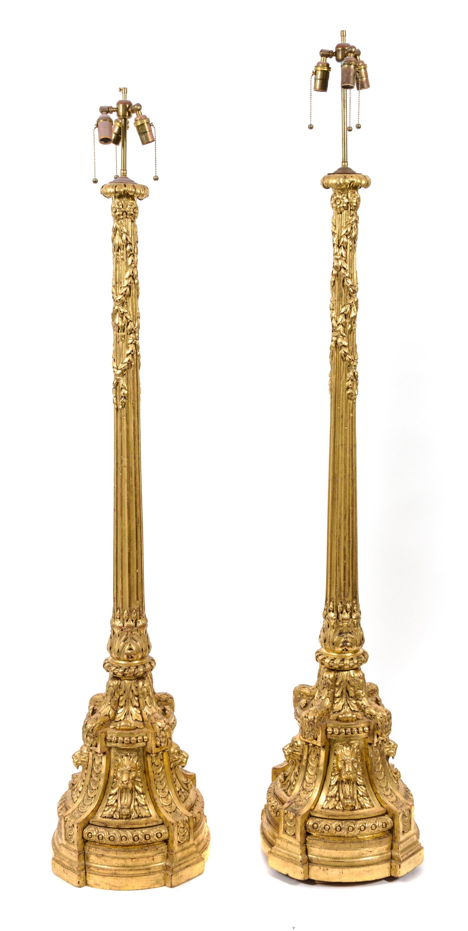 A Pair of Italian Giltwood Torcheres Height 66 x diameter 16 inches.