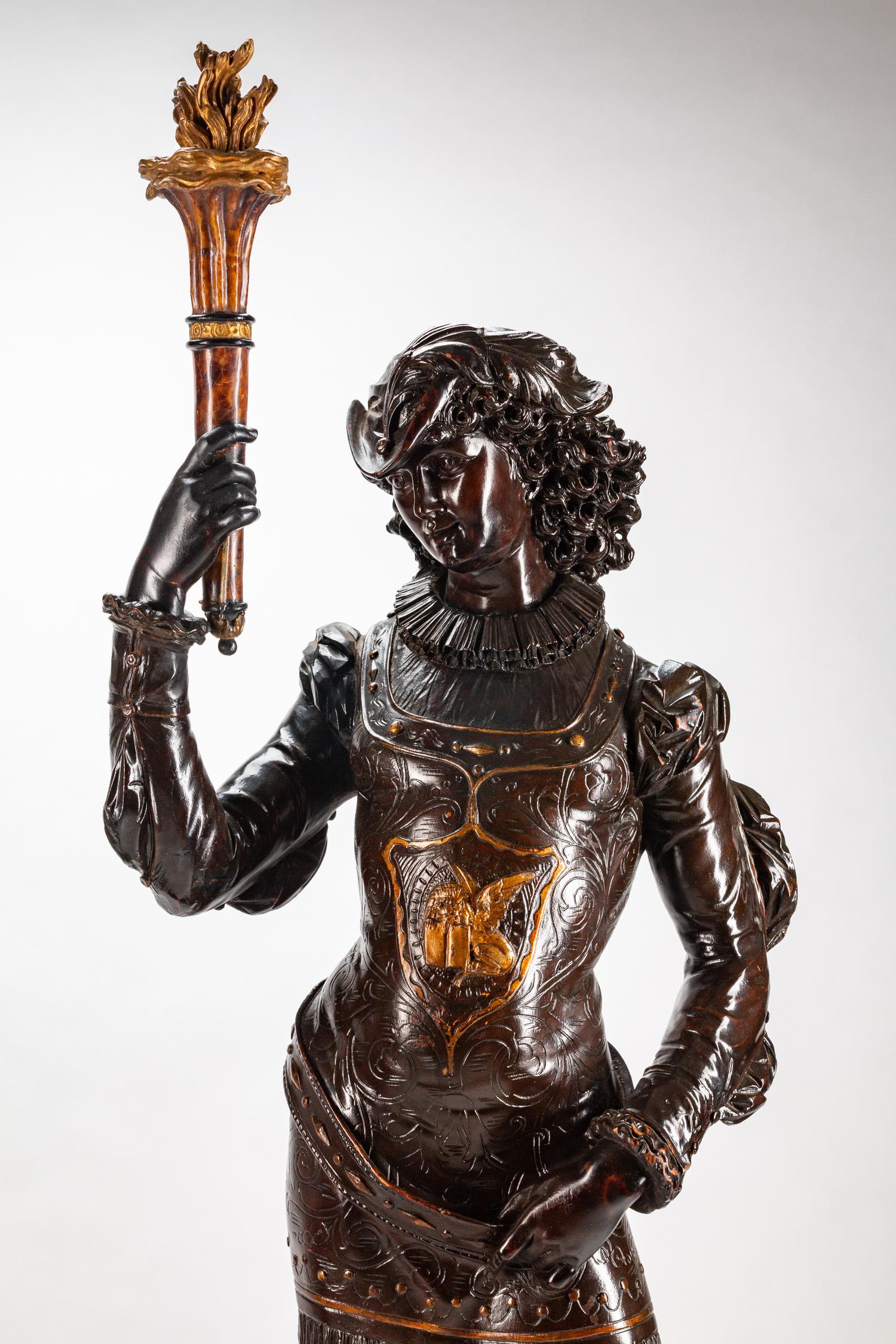 A Large Pair of English Parcel-Gilt and Stained Wood Figural Torchères on Stands