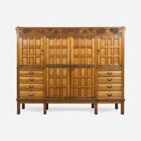 A large English Aesthetic Movement oak wardrobe Attributed to Richard Norman Shaw (1831-1912) & William Eden Nesfield (1835-1888), retailed by Maple & Co. (est. 1841), London, England, circa 1870