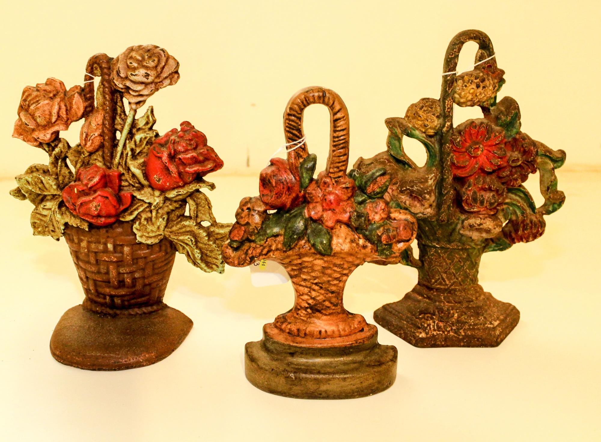 Three Victorian Cast Iron Doorstops Height of tallest 9 1/2 inches.