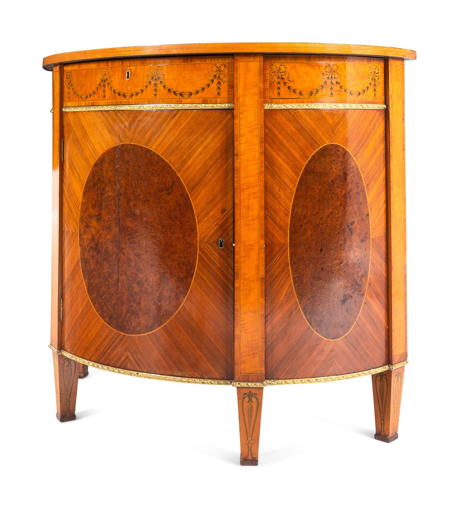 A Pair of George III Gilt Bronze Mounted Tulipwood, Burr Yew and Satinwood Marquetry Demilune Cabinets