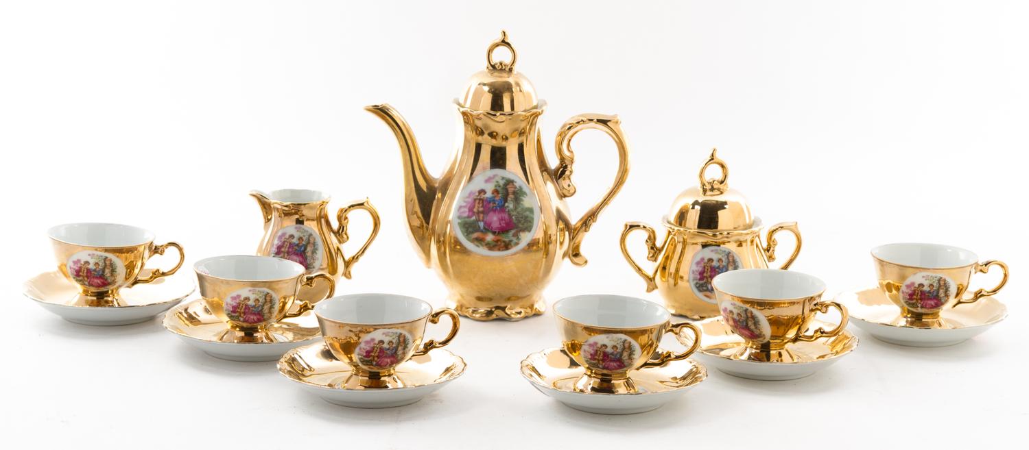 An Austrian Gilt and Painted Porcelain Tea Service Height of teapot 7 1/2 inches.