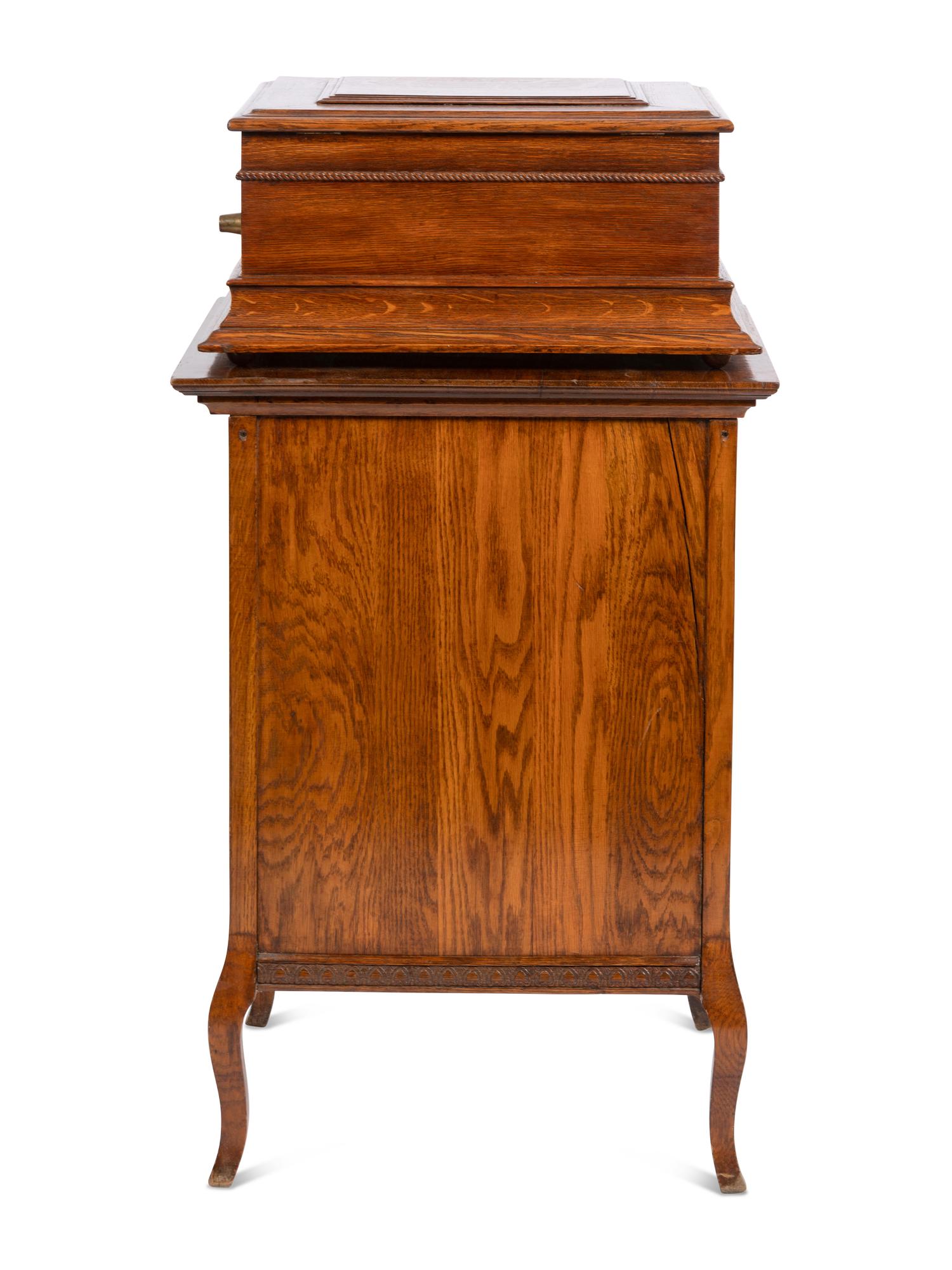 A Regina Coin Operated 15 1/2 Inch Disc Music Box and Stand