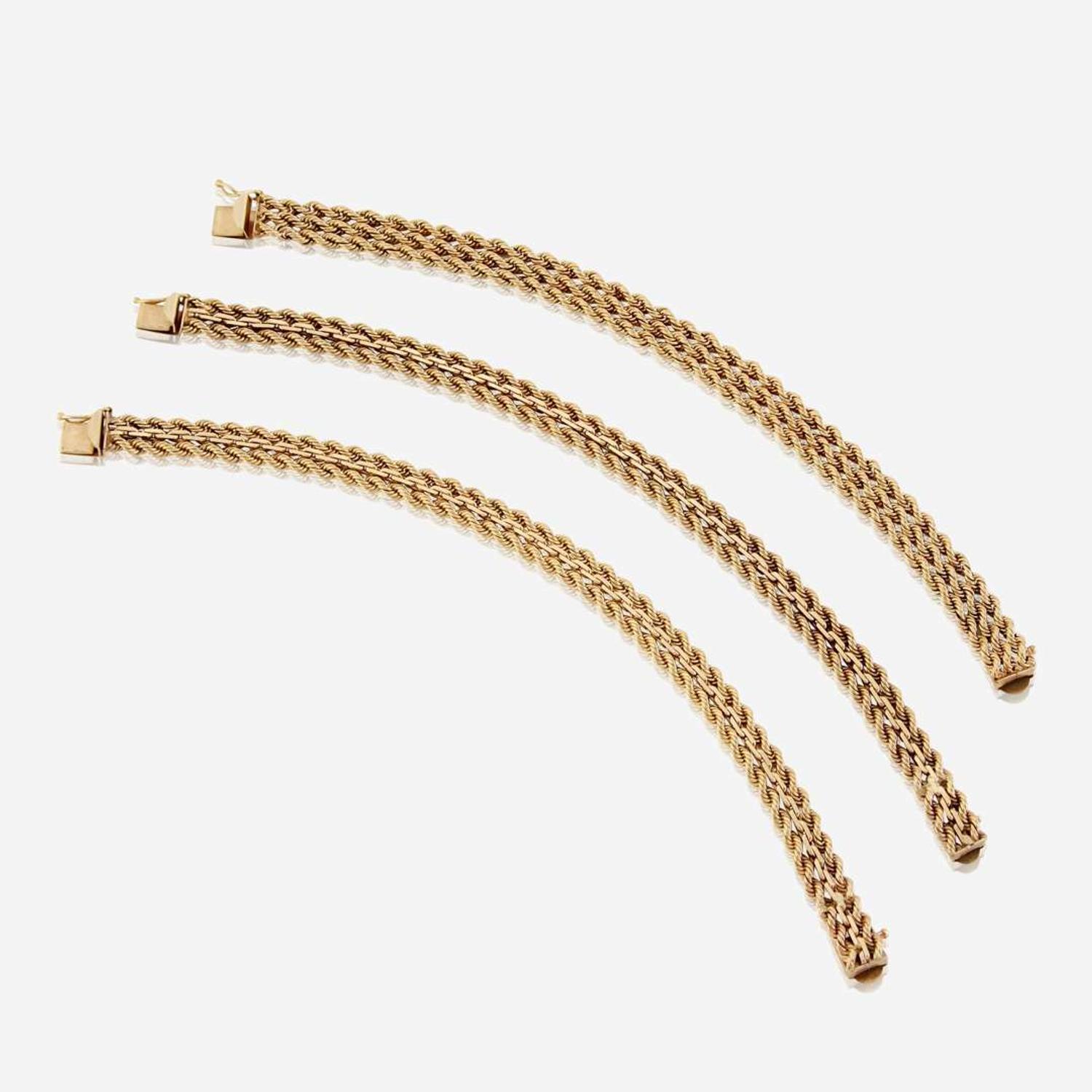 A collection of three fourteen karat gold bracelets