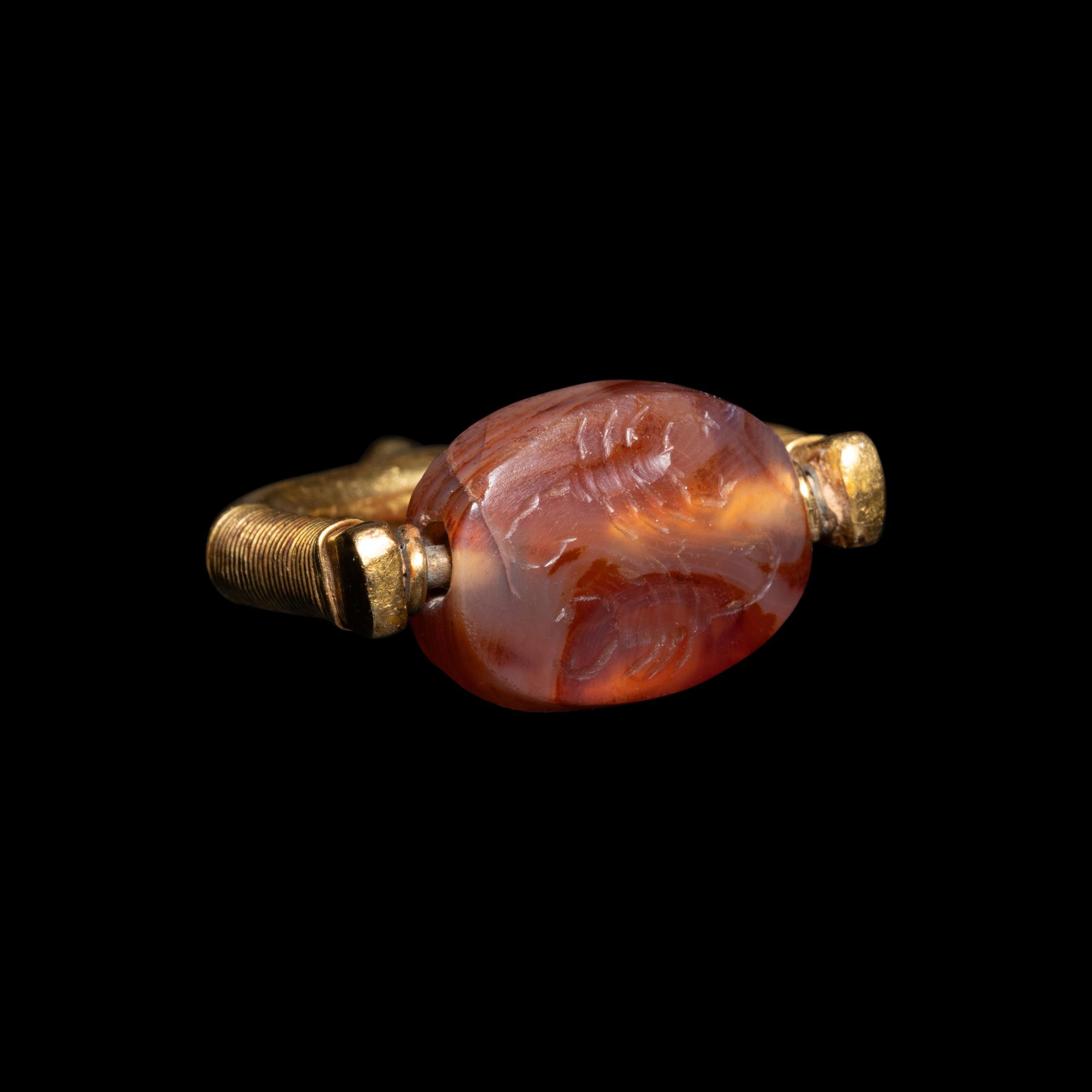 A Phoenician or Cypriot Gold and Carnelian Swivel Ring with Two Scorpions