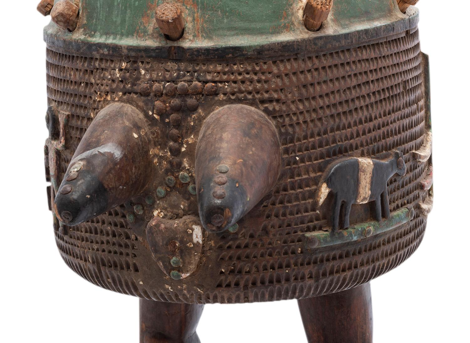 An Ashanti Carved and Gouged Painted Wood Breasted Drum