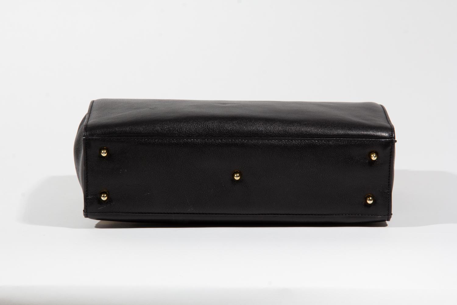 A Gianni Versace Black Leather Medusa Shoulder Bag, 11.75" x 8.5" x 3.5"; Strap drop: 19.5".