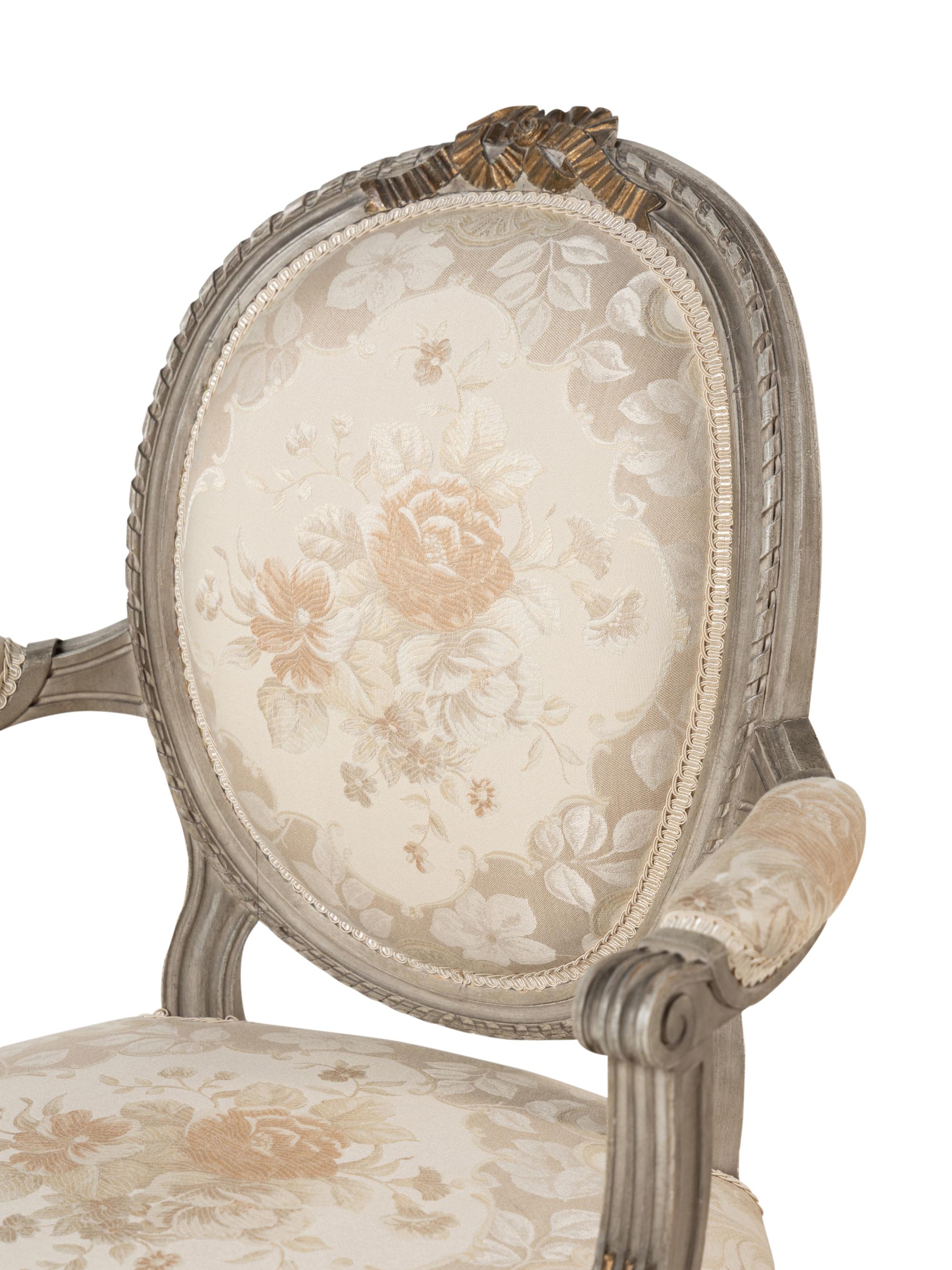 A Pair of Louis XVI Style Gray-Painted and Parcel-Gilt Armchairs