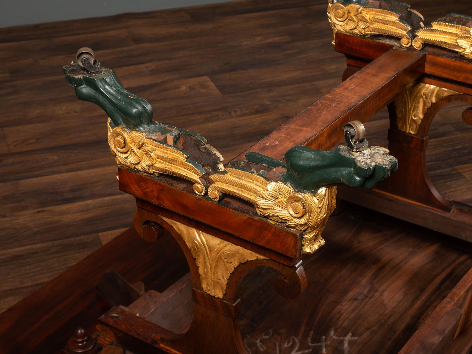 A Classical Parcel Gilt and Ebonized, Figured Mahogany Paw-Foot Drop-Leaf Table