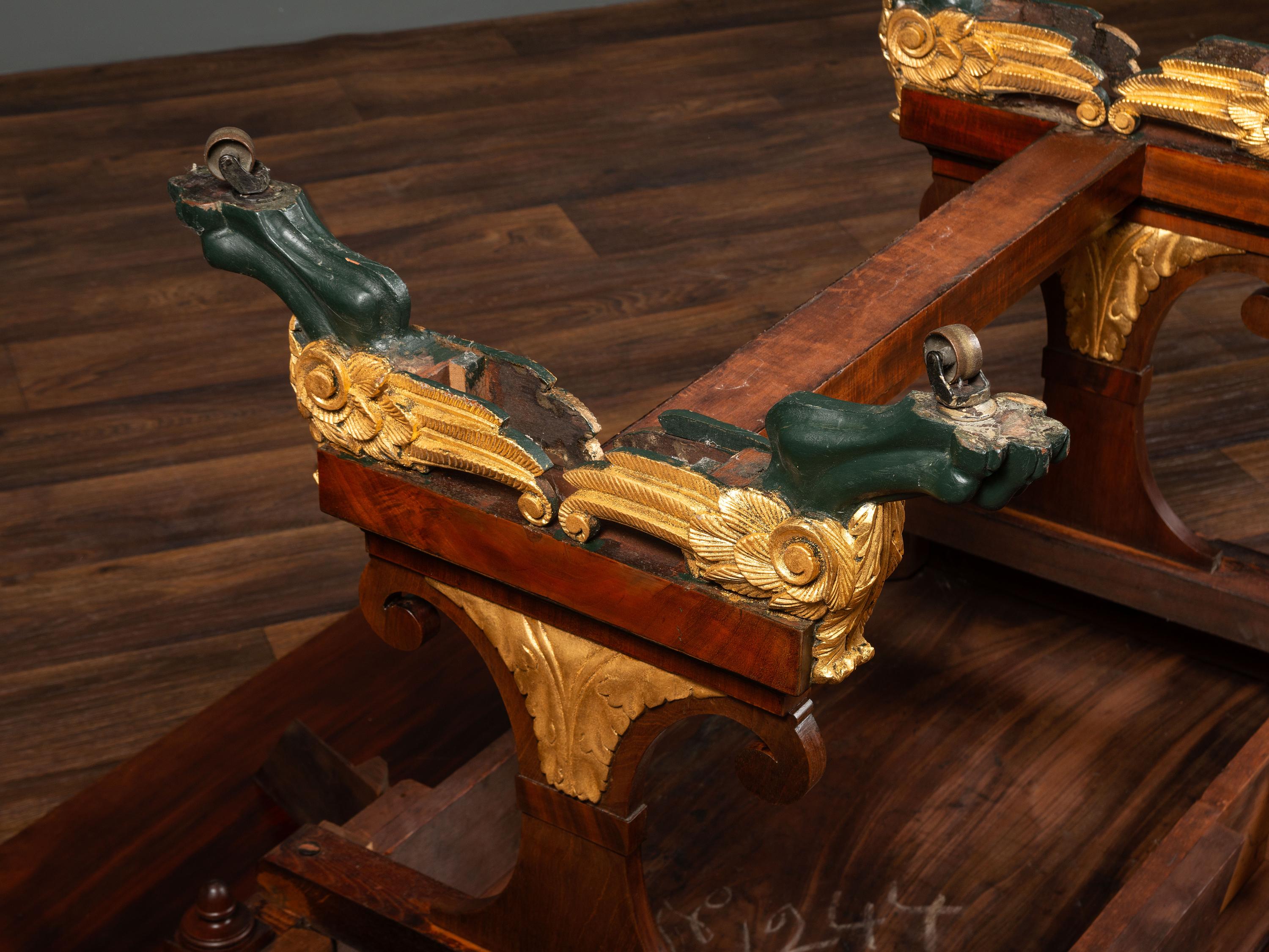 A Classical Parcel Gilt and Ebonized, Figured Mahogany Paw-Foot Drop-Leaf Table
