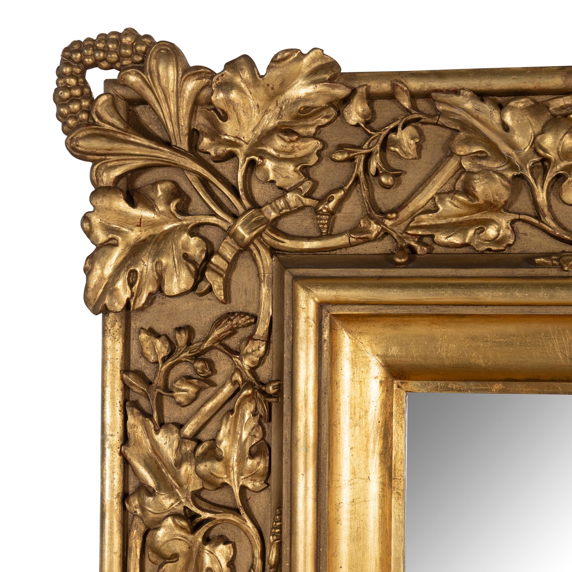 A Baroque Style Carved Giltwood and Gesso Figural Mirror