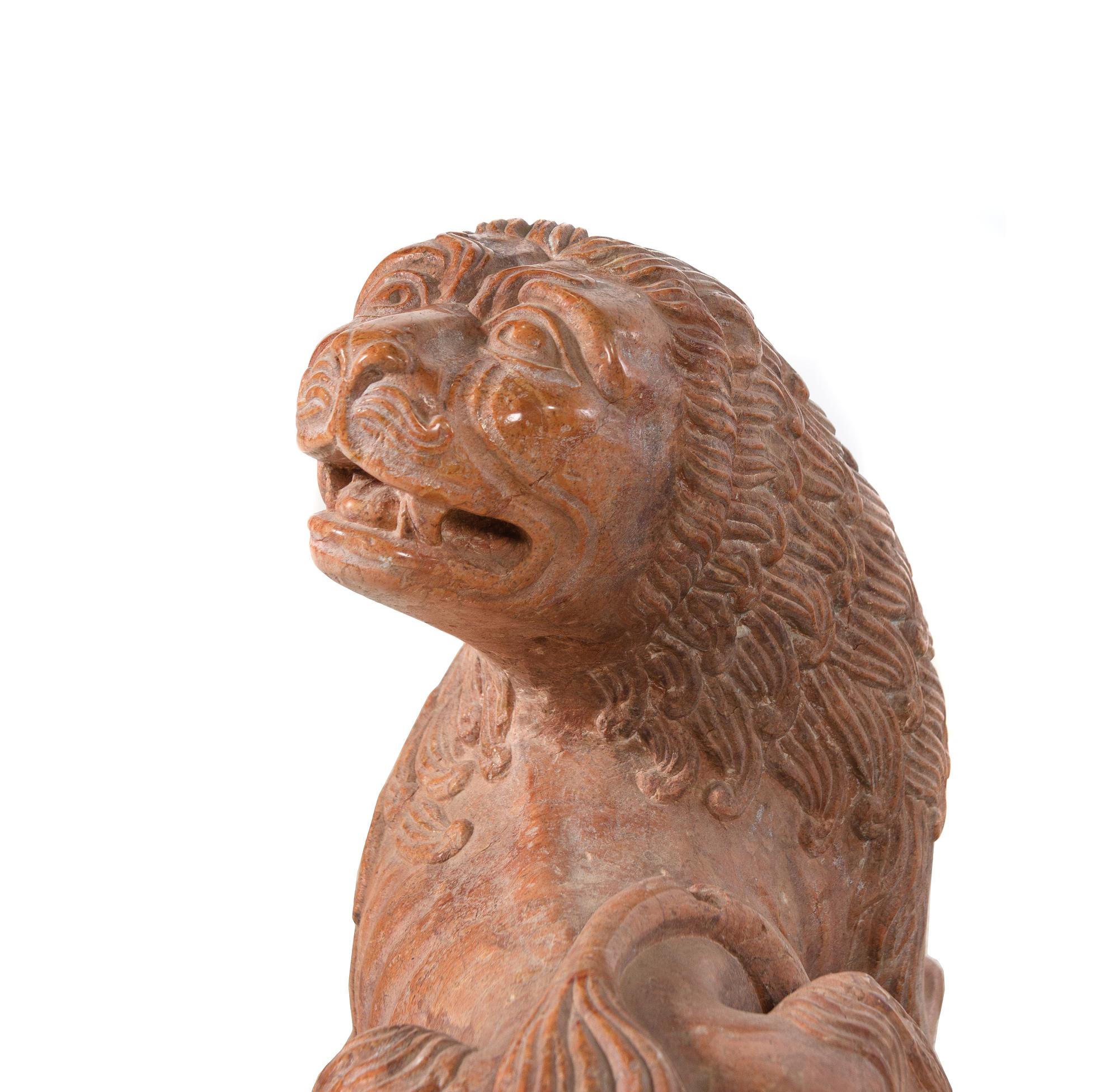 A Continental Carved Figure of a Recumbent Lion