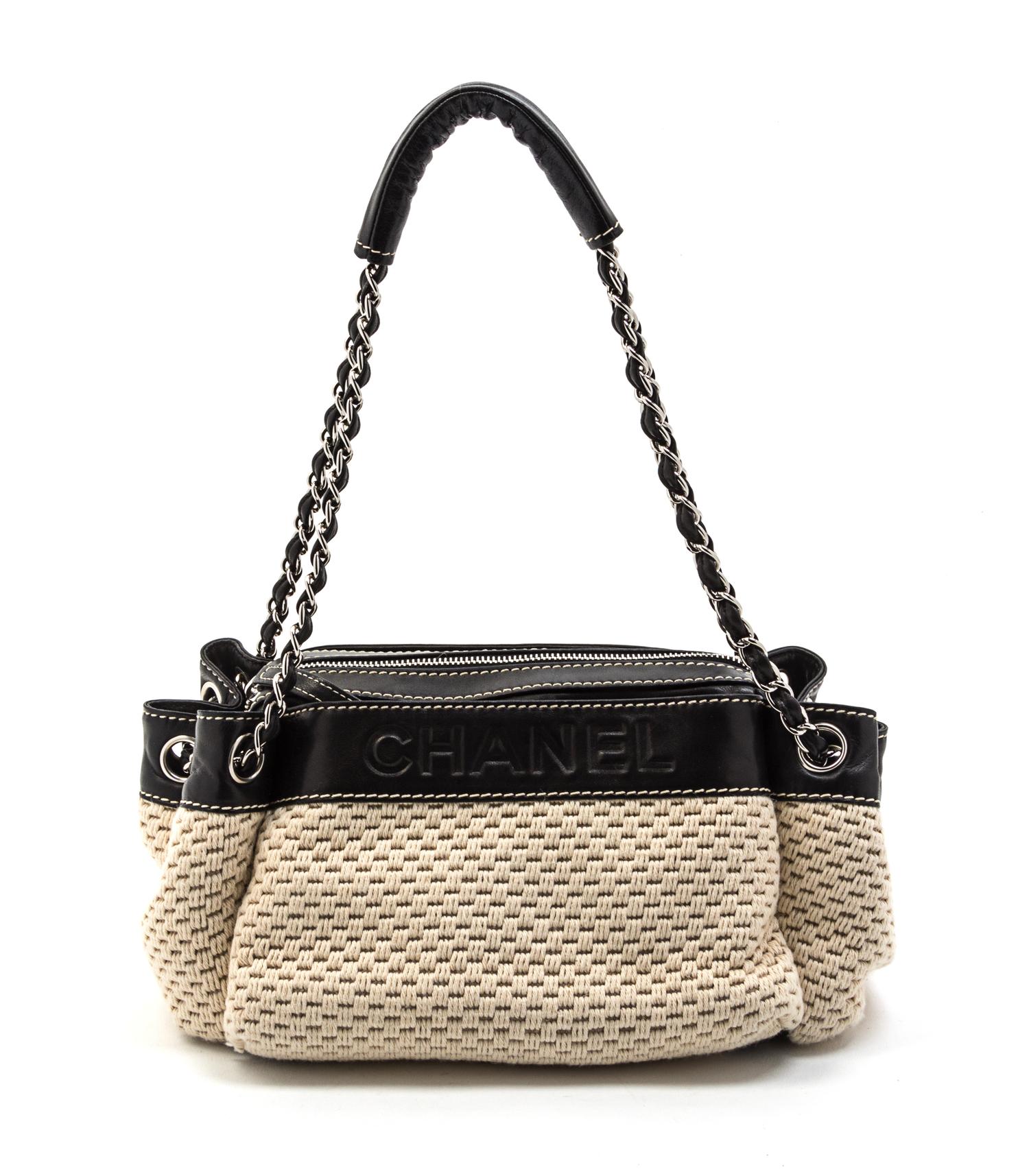 A Chanel Ivory Woven and Black Leather Trim Bag, 11 x 6 x 5 inches.