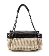 A Chanel Ivory Woven and Black Leather Trim Bag, 11 x 6 x 5 inches.