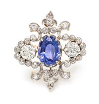 An Edwardian Platinum Topped Gold, Sapphire and Diamond Fleur-de-lys Brooch, 5.90 dwts.