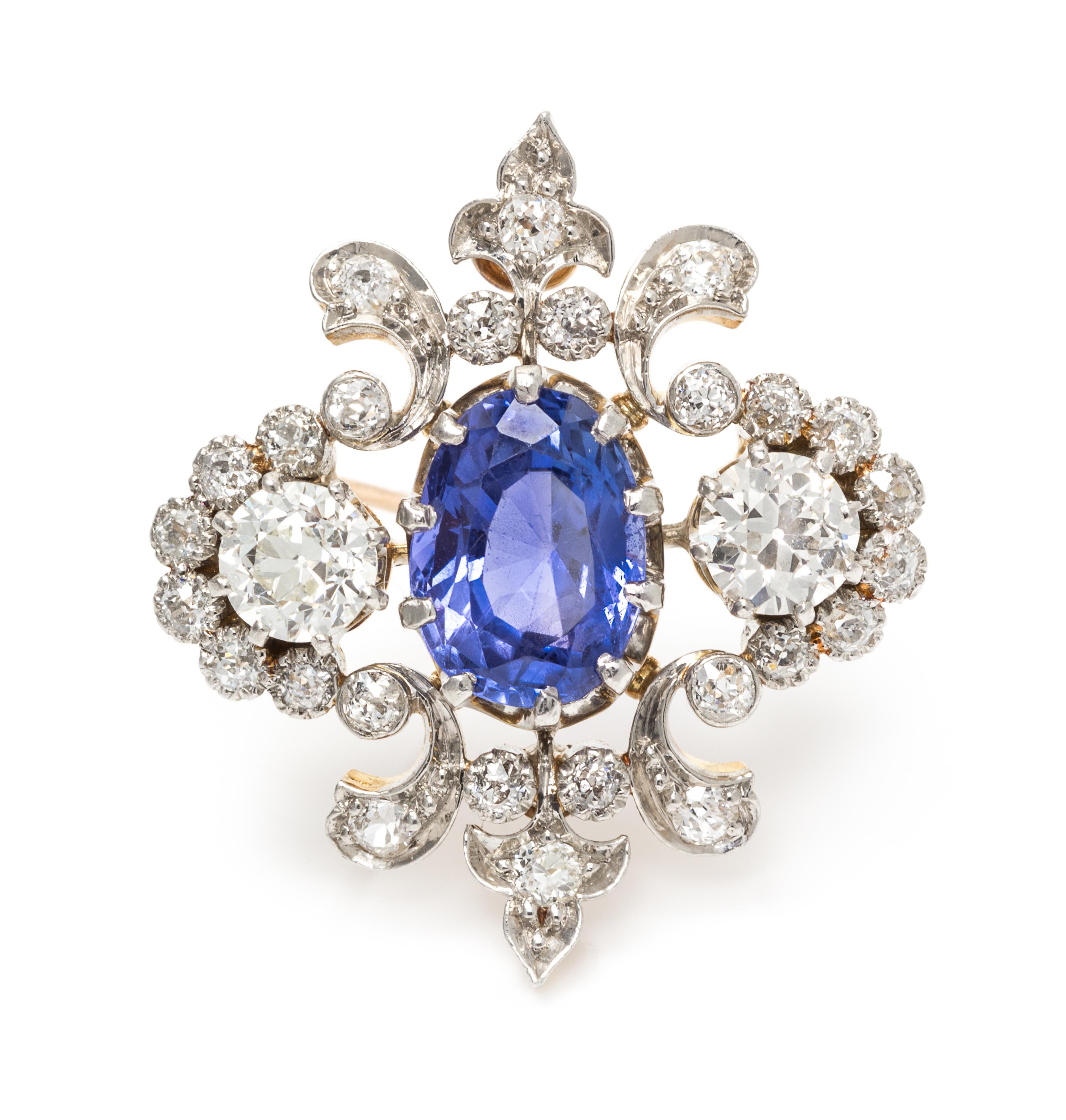 An Edwardian Platinum Topped Gold, Sapphire and Diamond Fleur-de-lys Brooch, 5.90 dwts.