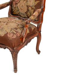A Pair of Régence Style Carved Walnut Fauteuils