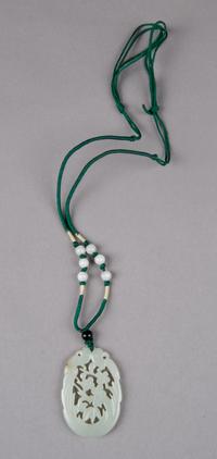A Chinese Celadon Jade Oval Plaque, Height 2 inches.