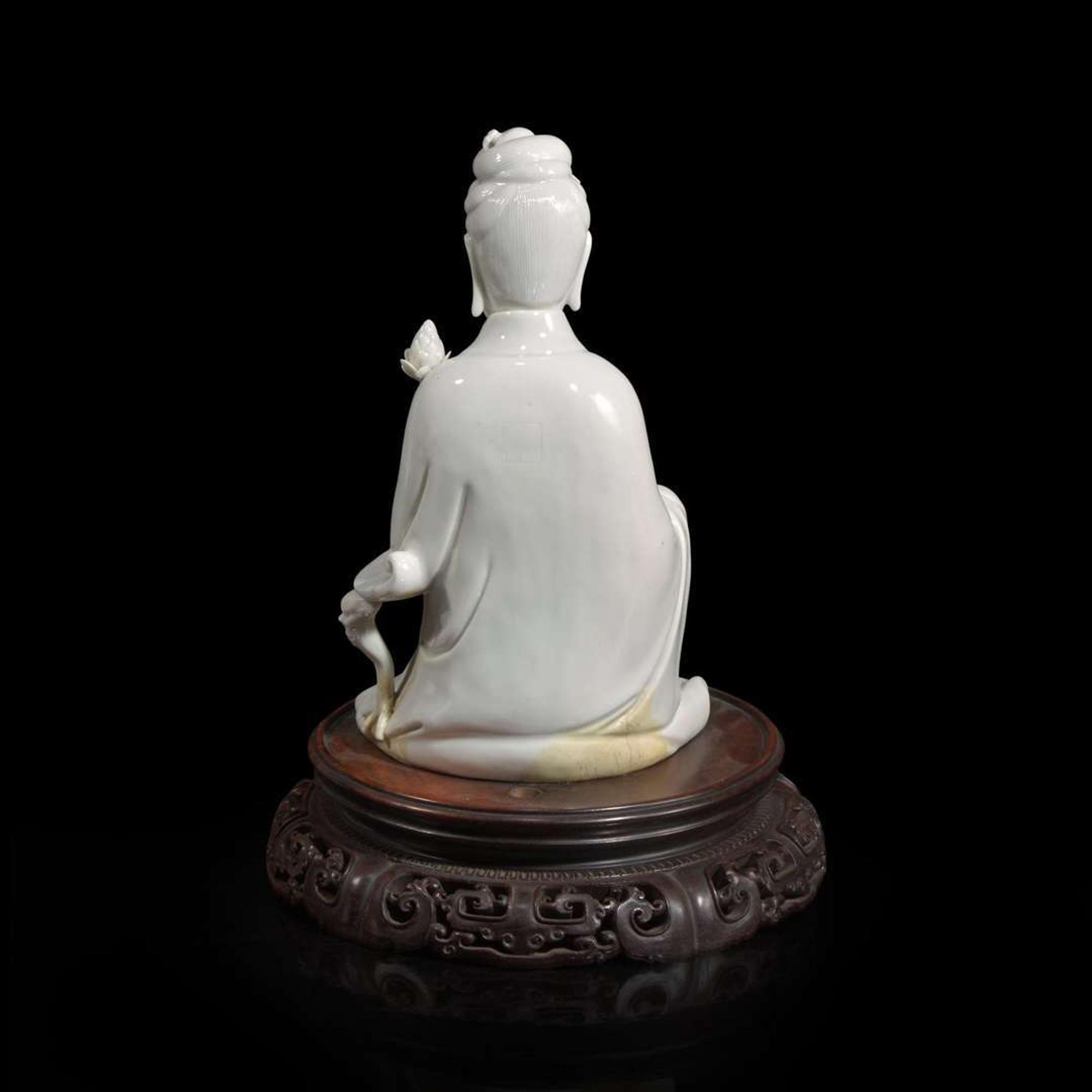 A Chinese blanc de Chine figure of Guanyin seated, with lotus 白瓷持莲观音像 Boji Yuren seal mark ?????