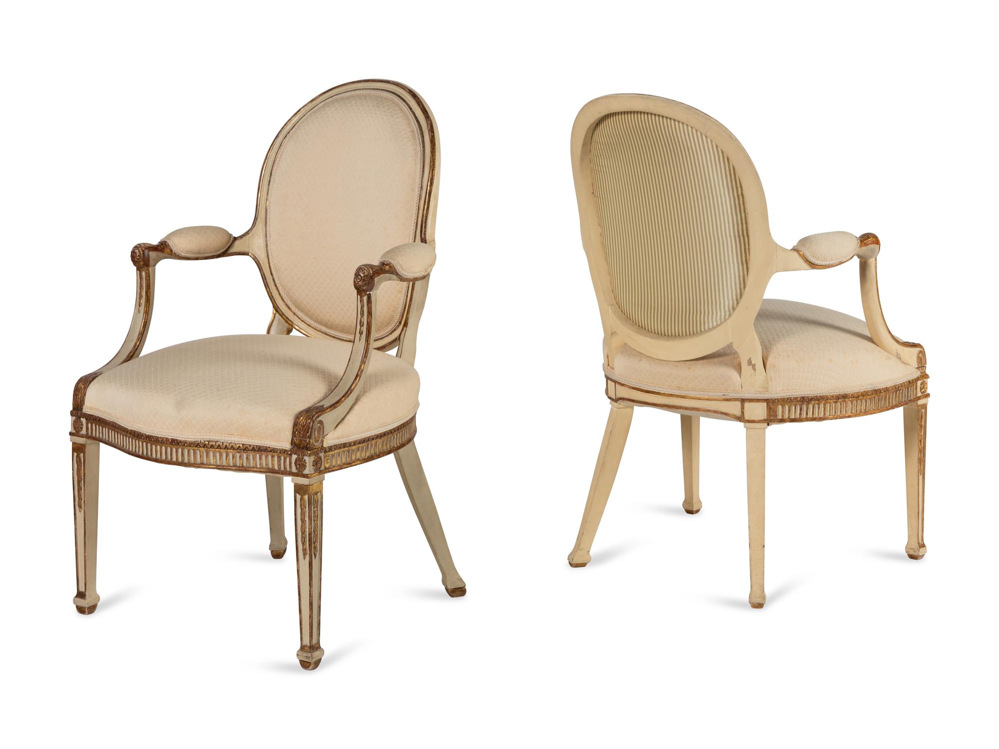 A Pair of Louis XVI Style Crème-Painted and Parcel Gilt Fauteuils