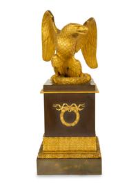 A Gilt Bronze Eagle Sculpture on an Empire Style Gilt and Patinated Bronze Base