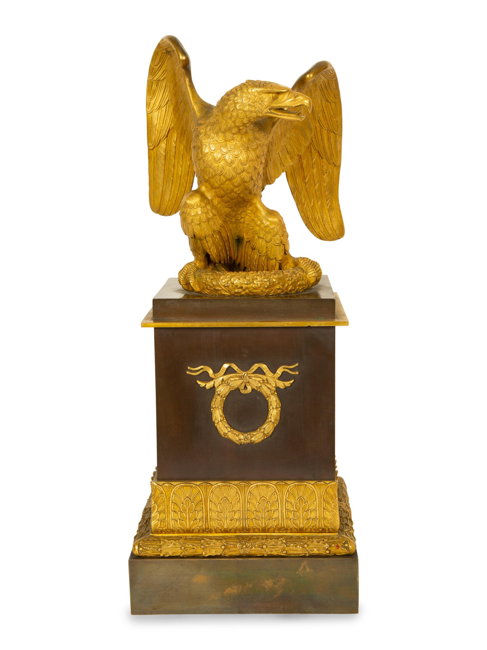 A Gilt Bronze Eagle Sculpture on an Empire Style Gilt and Patinated Bronze Base