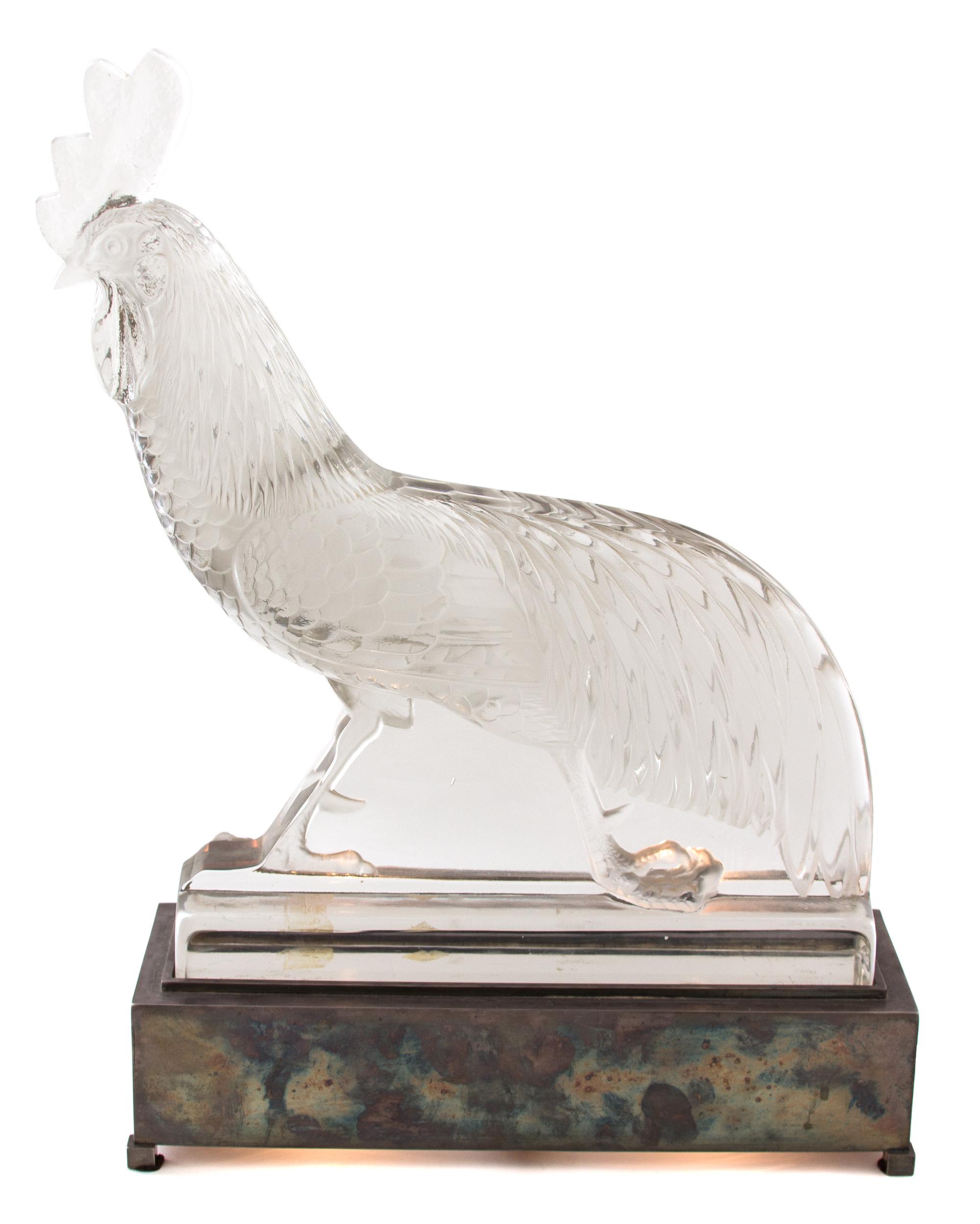 A Rene Lalique Molded and Frosted Glass Coq au Jungle Height 16 1/8 x width 16 1/2 x depth 3 1/2 inches.