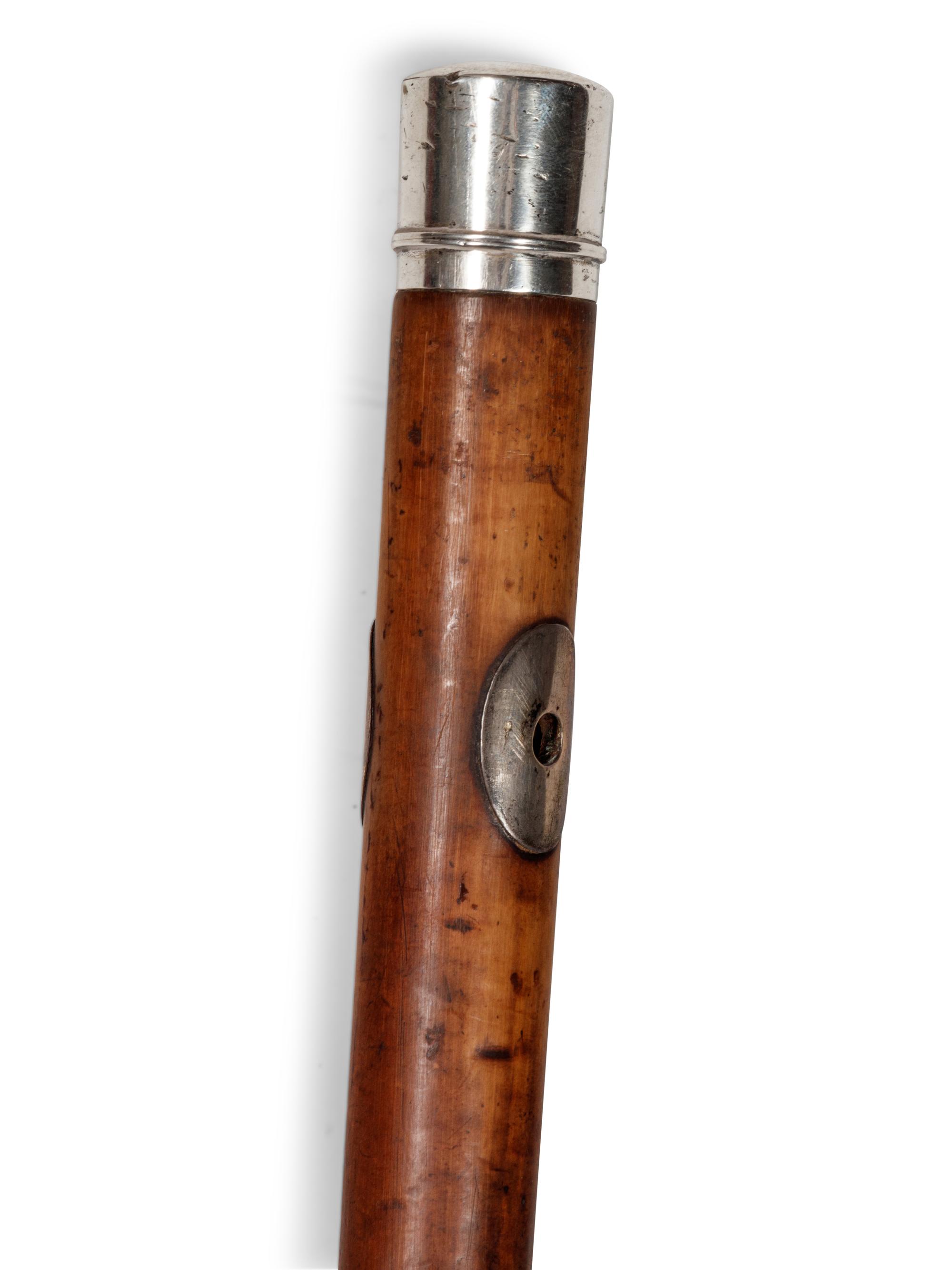 A Silvered Metal Mounted Malacca Bootmaker's 'System' Walking Stick