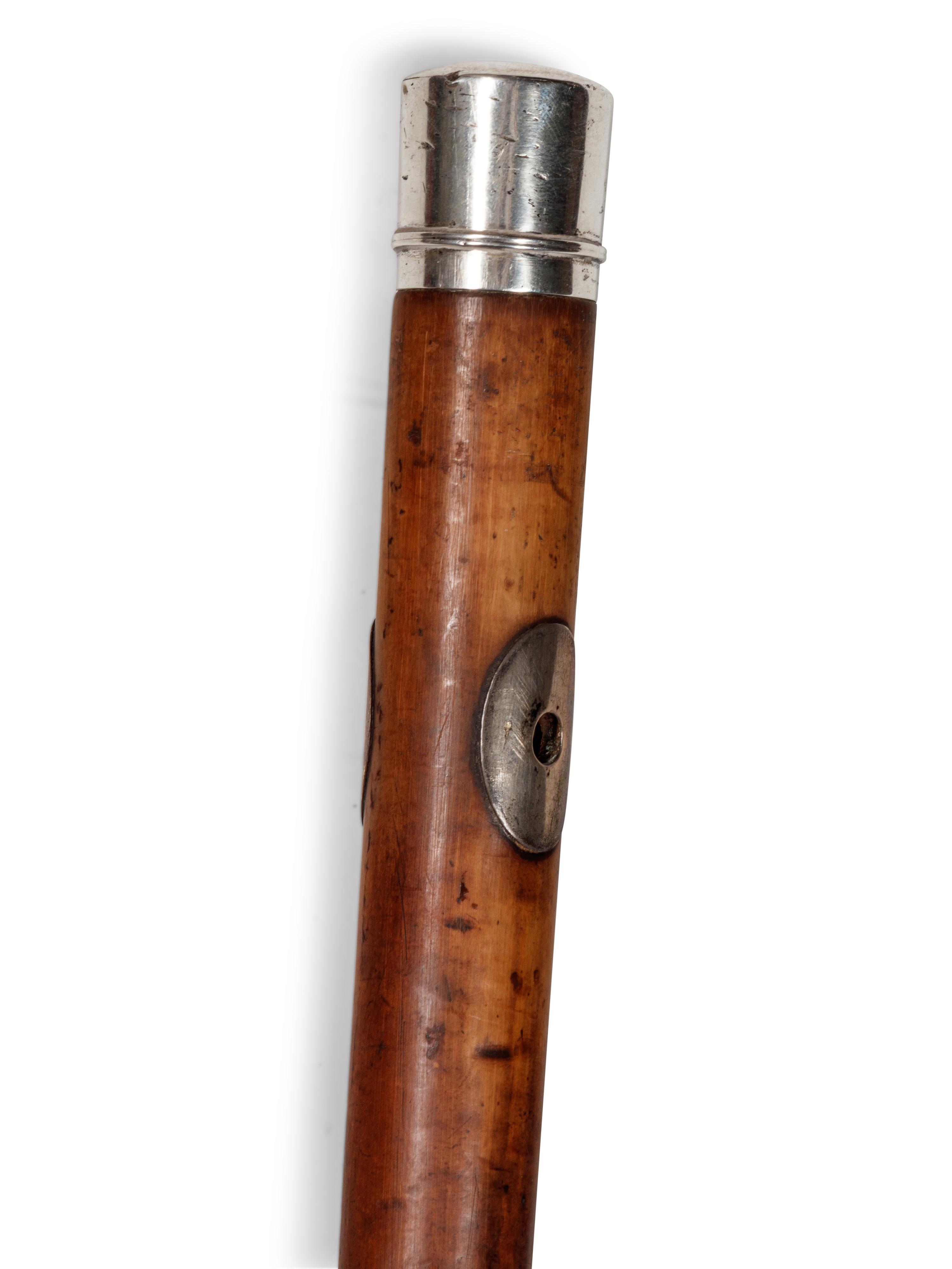 A Silvered Metal Mounted Malacca Bootmaker's 'System' Walking Stick