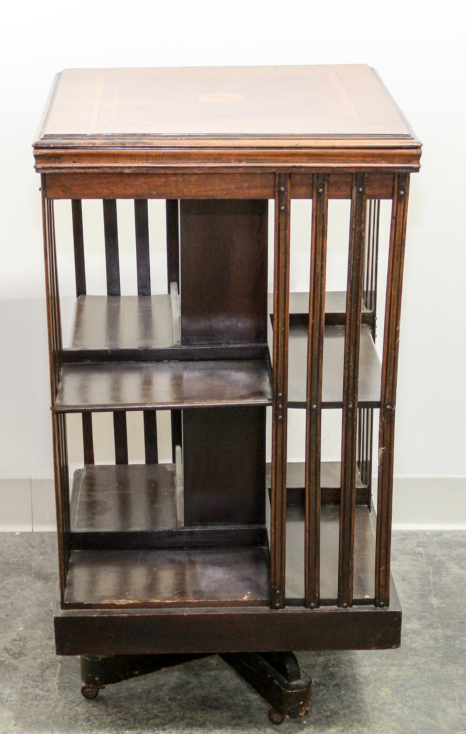 A Walnut Revolving Bookcase. Height 33 x width 18 x depth 18 inches.