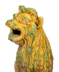 A Pair of Italian Yellow and Green Glazed Ceramic Figures of Seated Lions