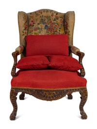 A Régence Style Carved Walnut Bergère à Oreilles with Petit Point Upholstery