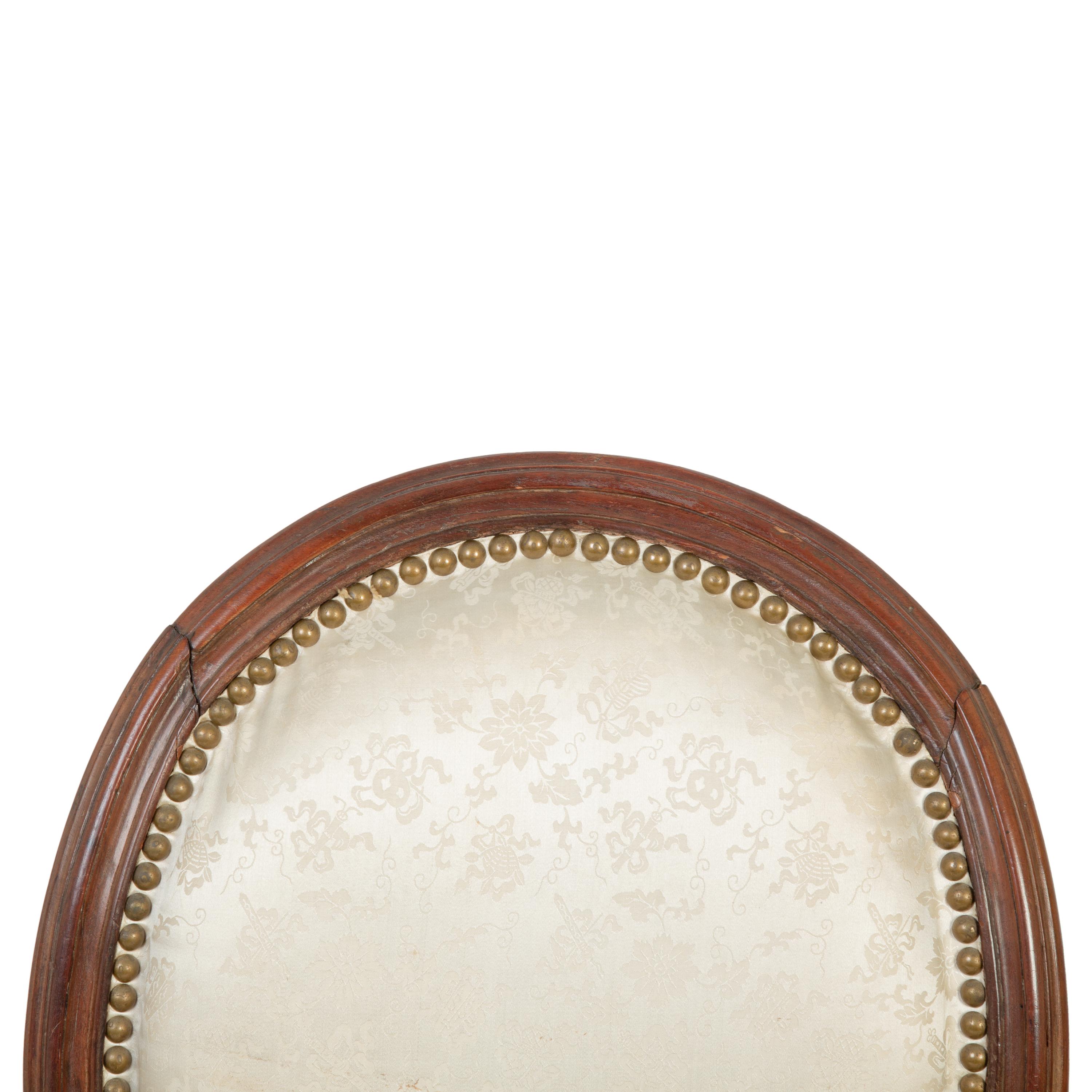 A Pair of Louis XVI Walnut Fauteuils en Cabriolet