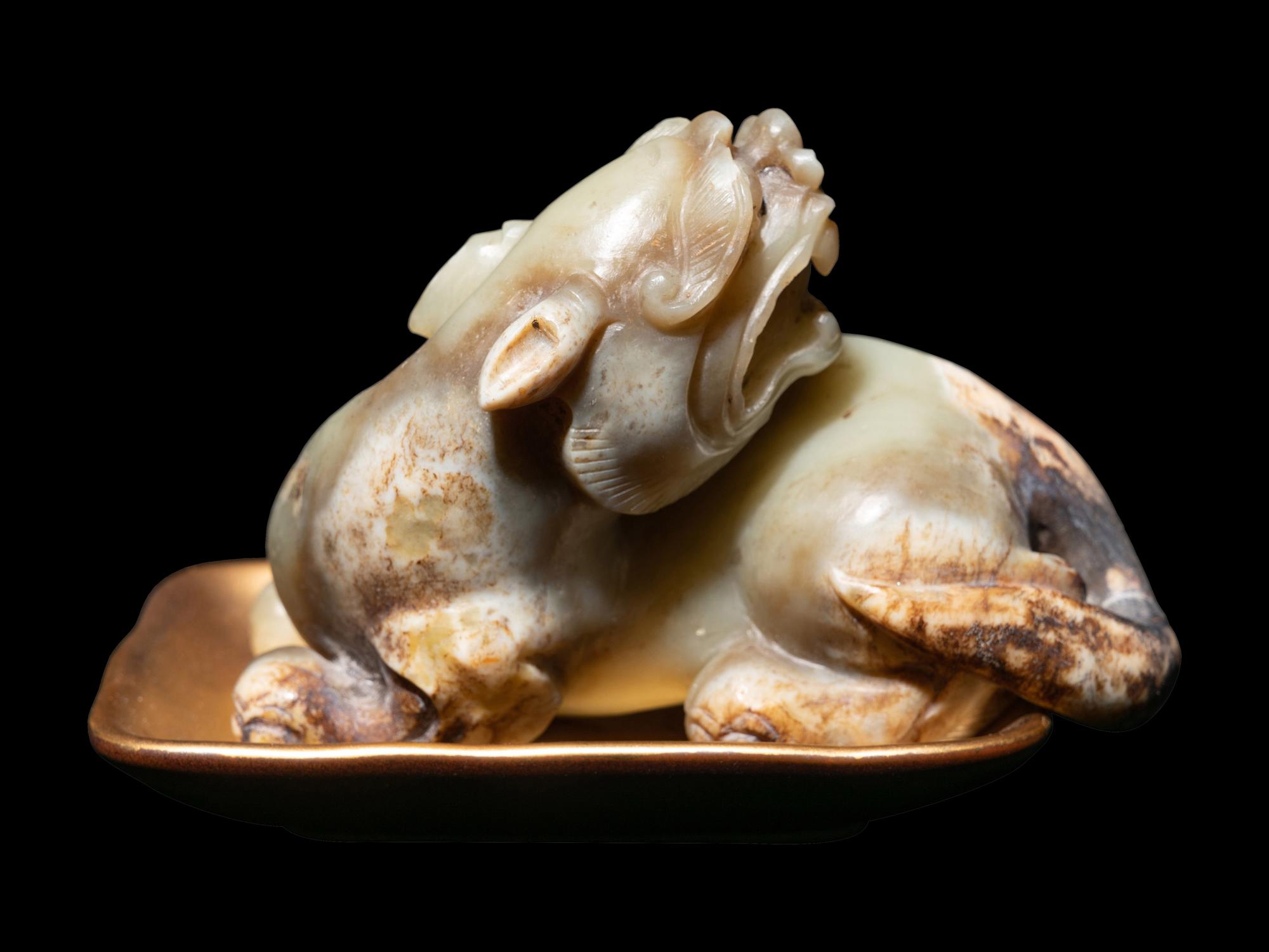 A Chinese Celadon Jade Figure of a Recumbent Bixie