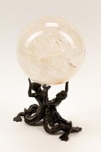 A Rock Crystal Spherical Ornament on a Patinated Bronze Figural Base