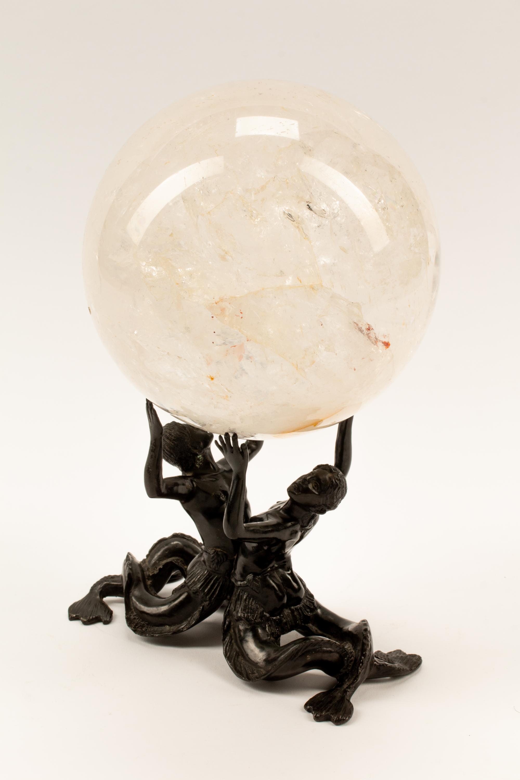 A Rock Crystal Spherical Ornament on a Patinated Bronze Figural Base