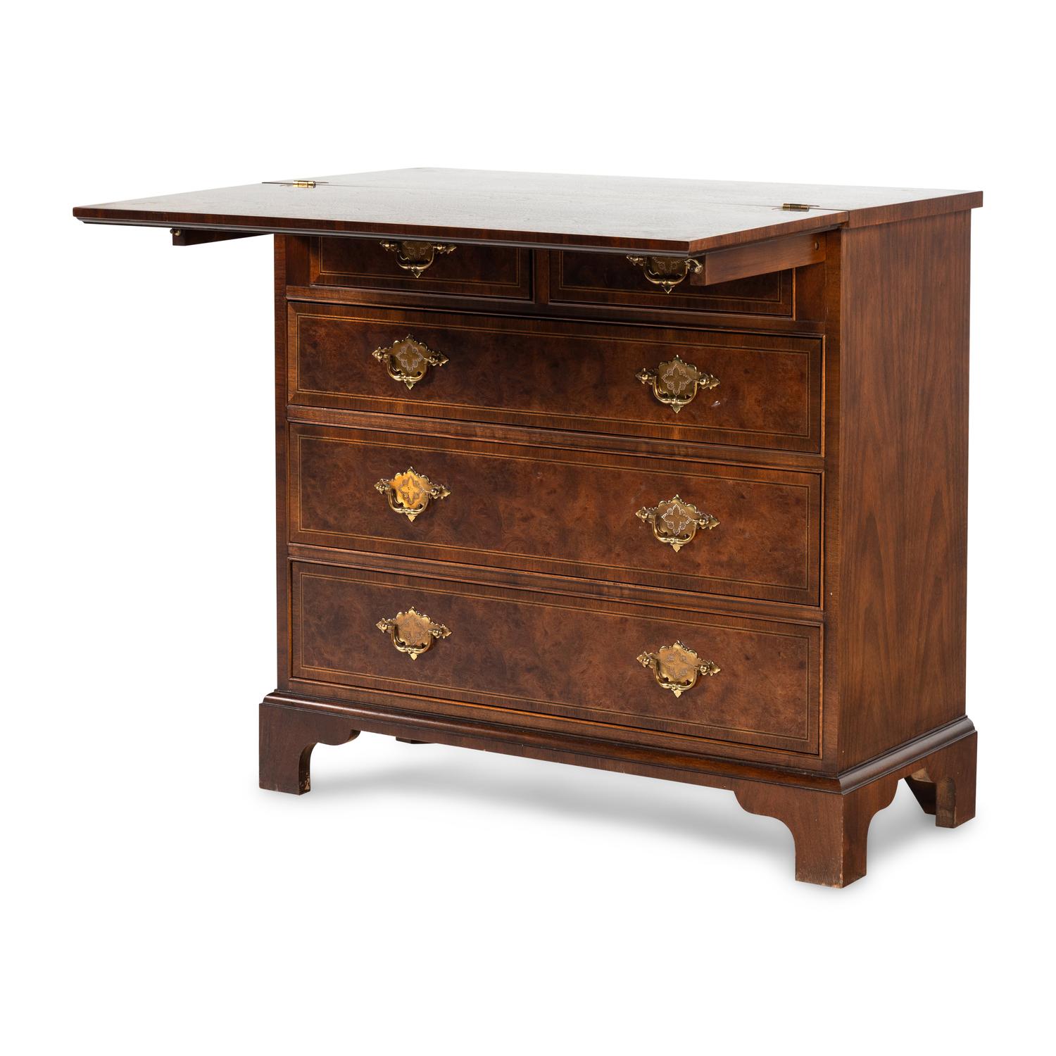 A Baker George III Style Walnut and Mahogany Bachelor's Chest
