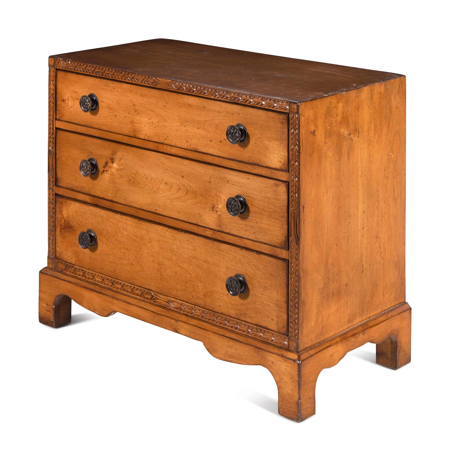 A Contemporary Carved Walnut Chest of Drawers