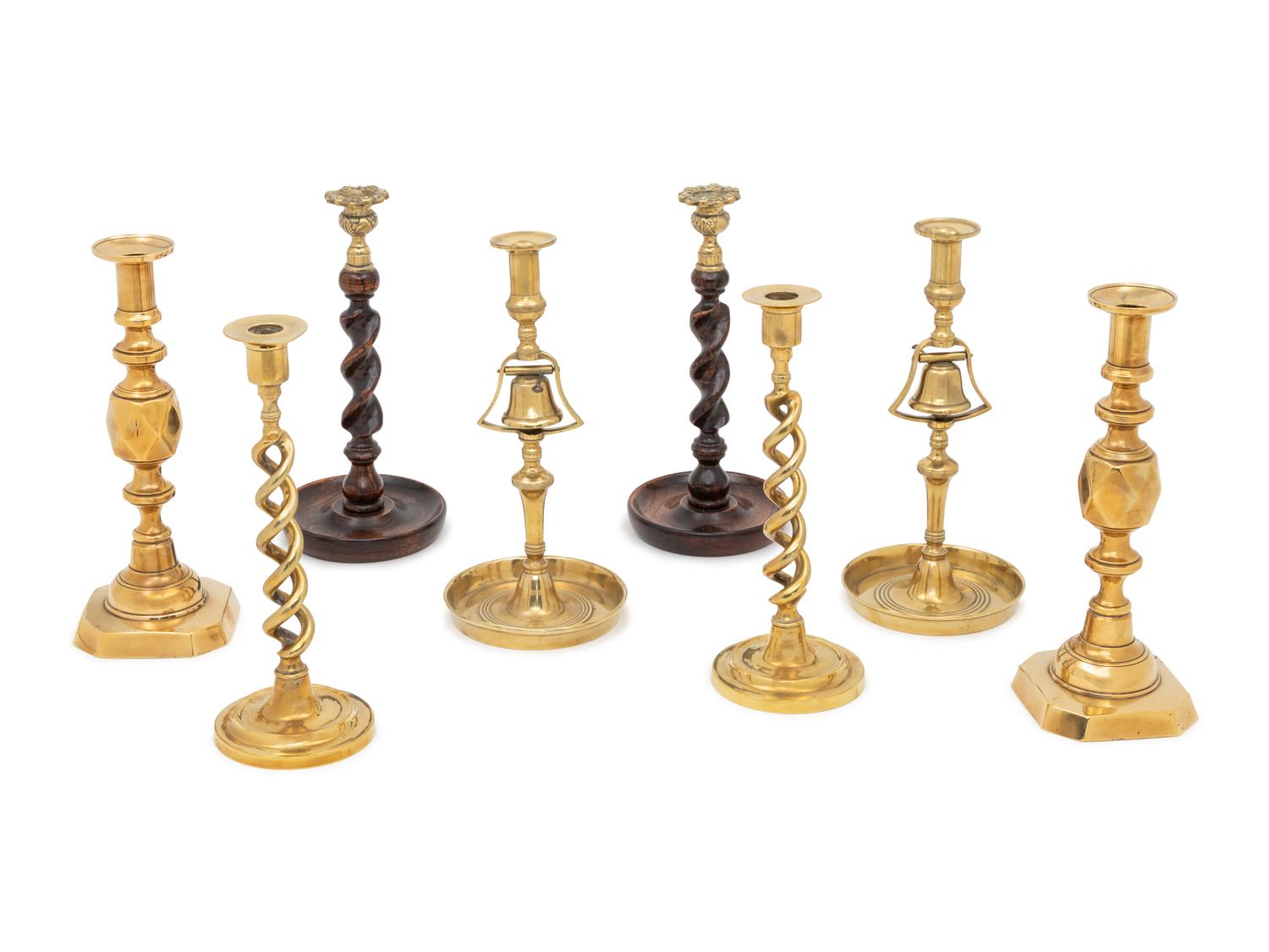 A Group of Four Pairs of English Brass Candlesticks