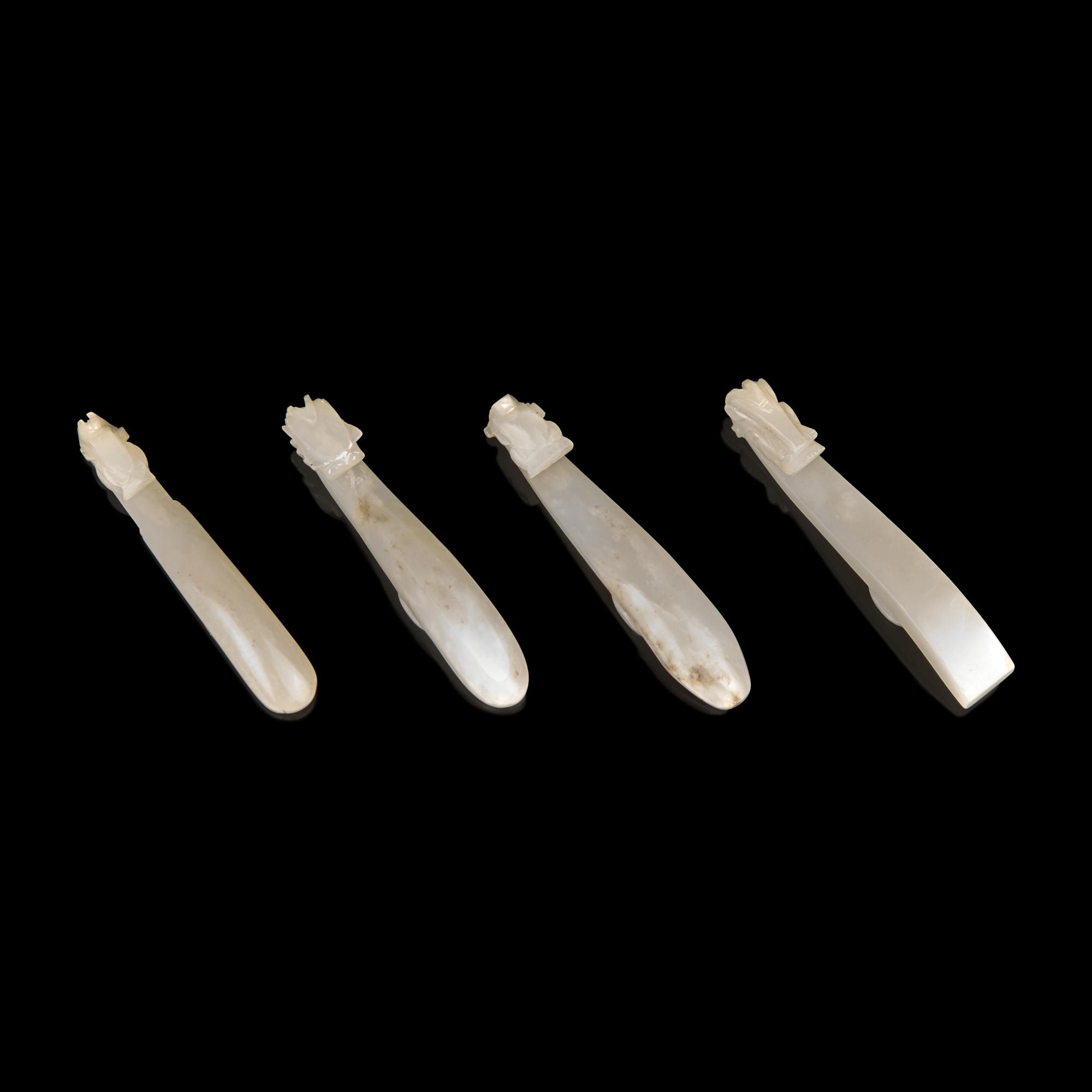 Four Chinese Greyish White Jade "Dragon" Head Belt Hooks, Qing Dynasty — 清 灰白玉龍鉤四件