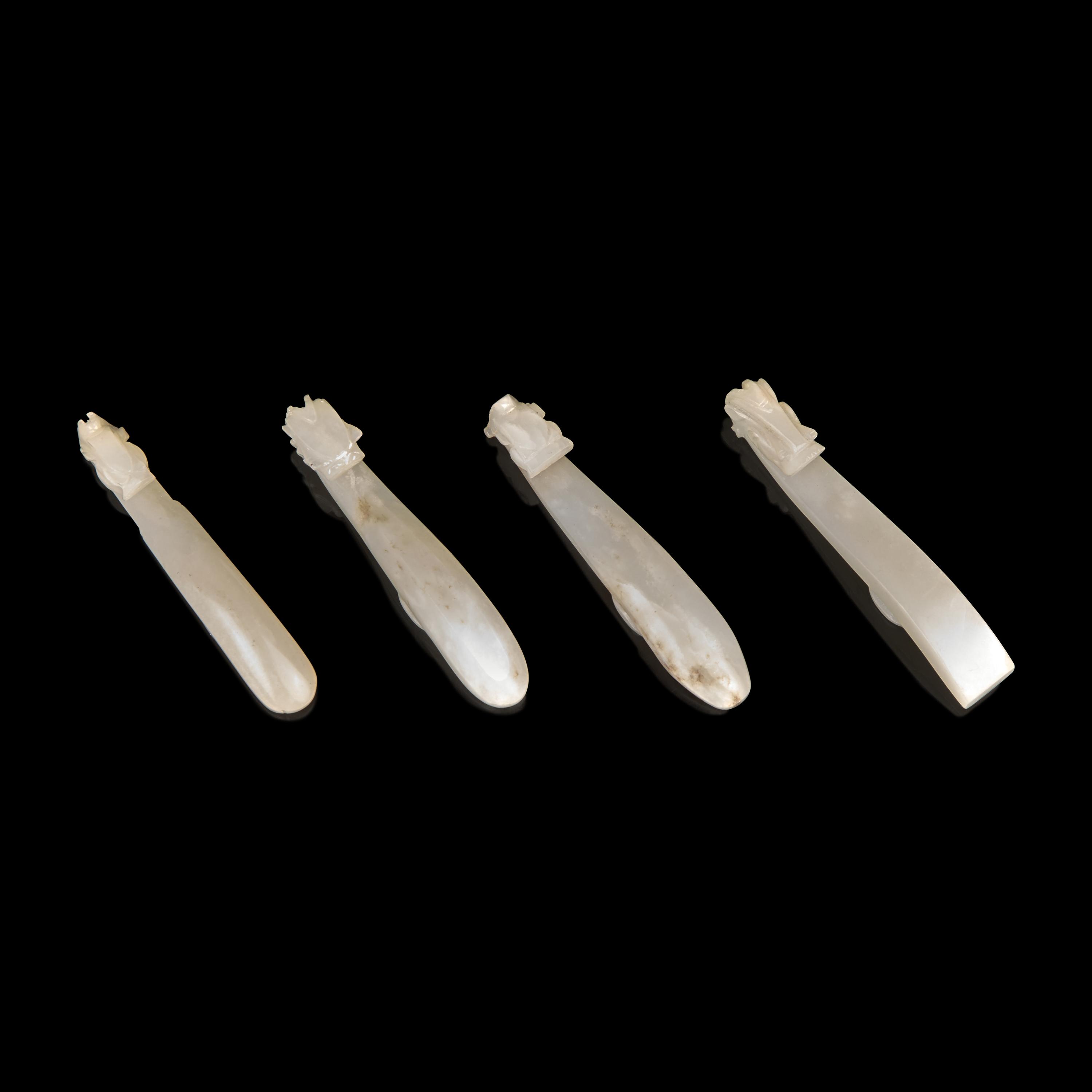 Four Chinese Greyish White Jade "Dragon" Head Belt Hooks, Qing Dynasty — 清 灰白玉龍鉤四件