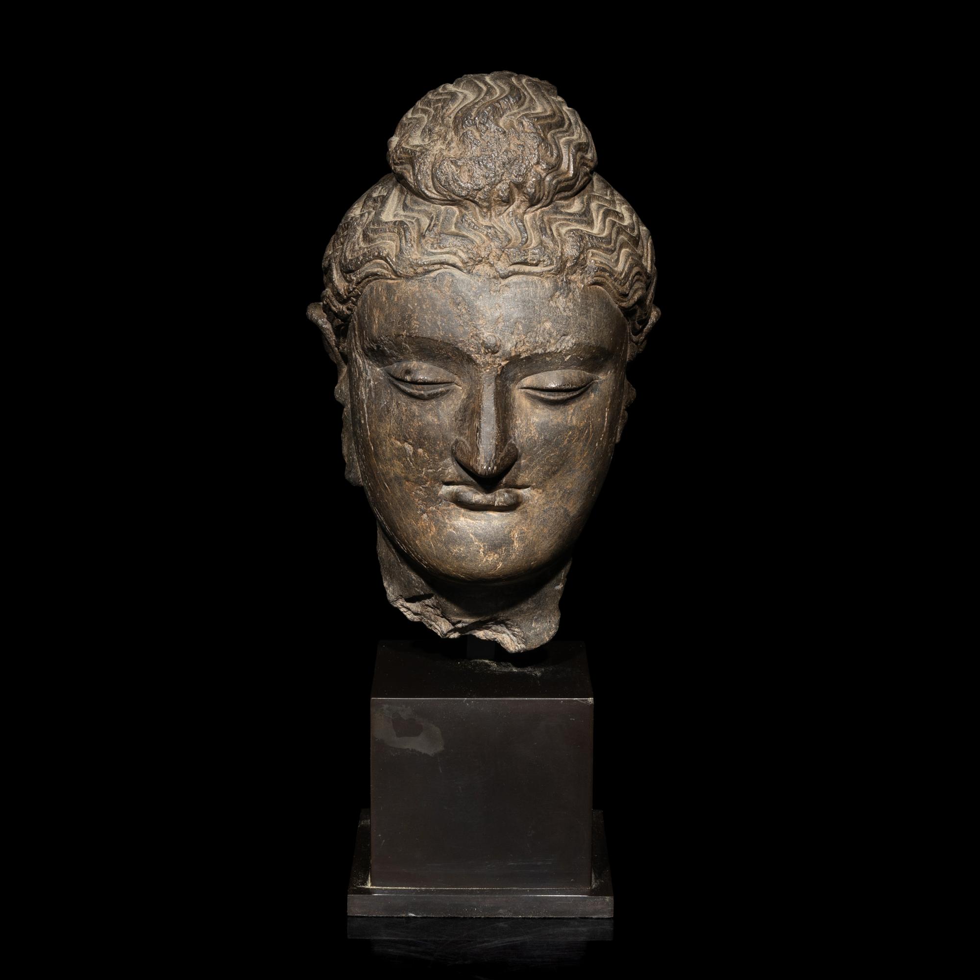 A Gandharan Grey Schist Head of Buddha, 3rd/4th Century