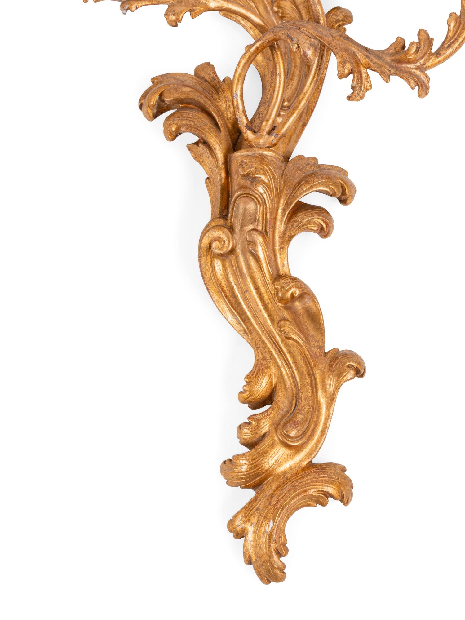 A Set of Four Italian Carved Giltwood Three-Light Sconces