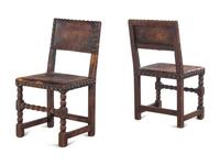 A Set of Four Spanish Baroque Style Oak Chairs with Leather Upholstery