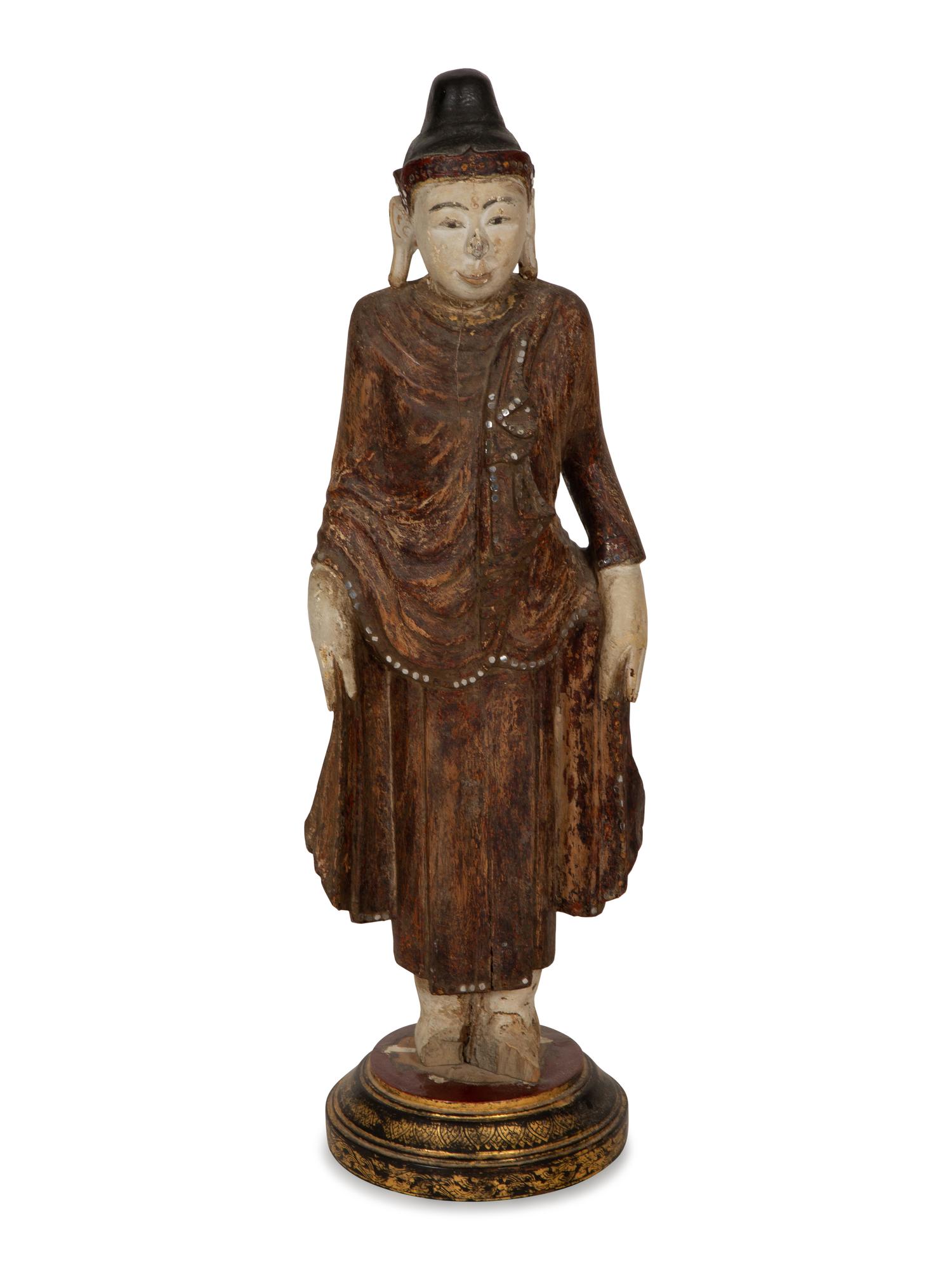 An Indonesian Carved and Painted Figure of a Buddhist Monk