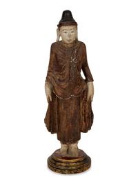 An Indonesian Carved and Painted Figure of a Buddhist Monk