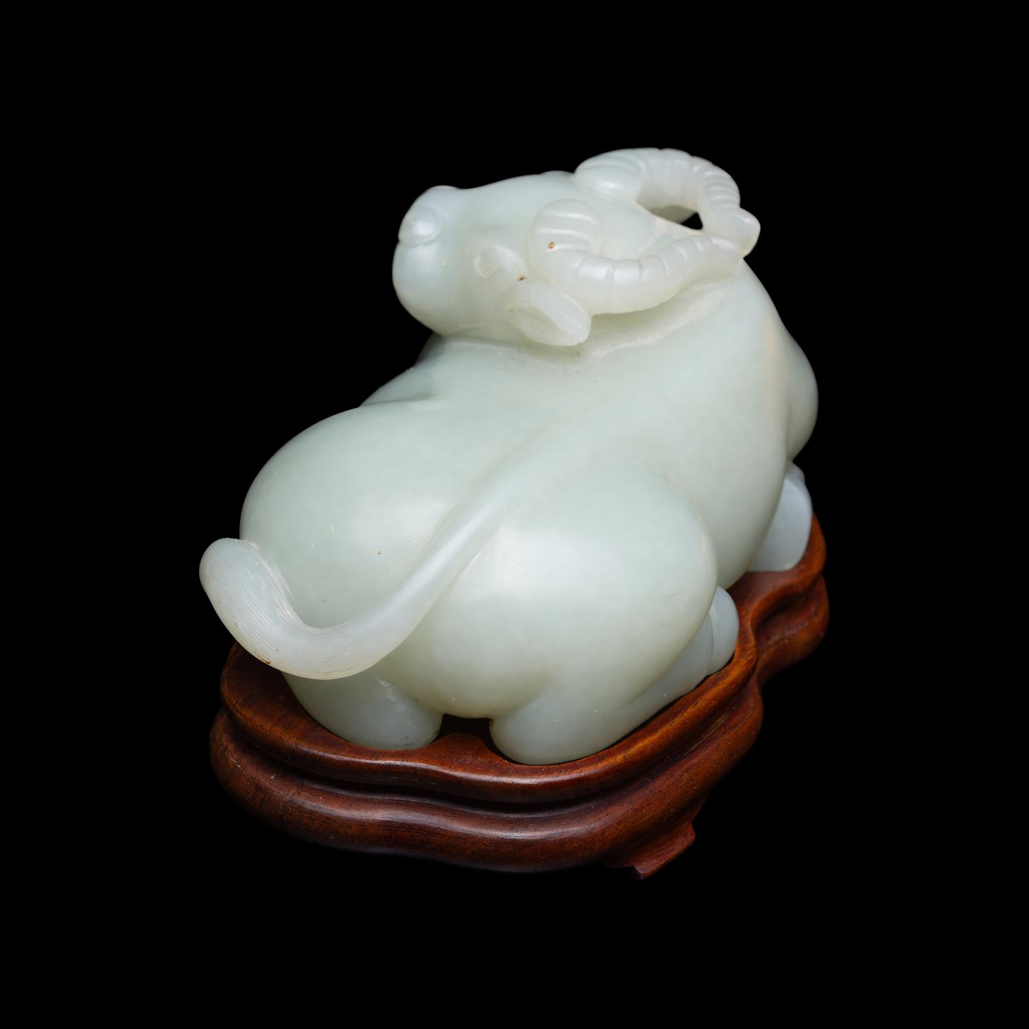 A Chinese Pale Celadon Jade Figure of a Recumbent Buffalo, Qing Dynasty 清 青玉臥牛