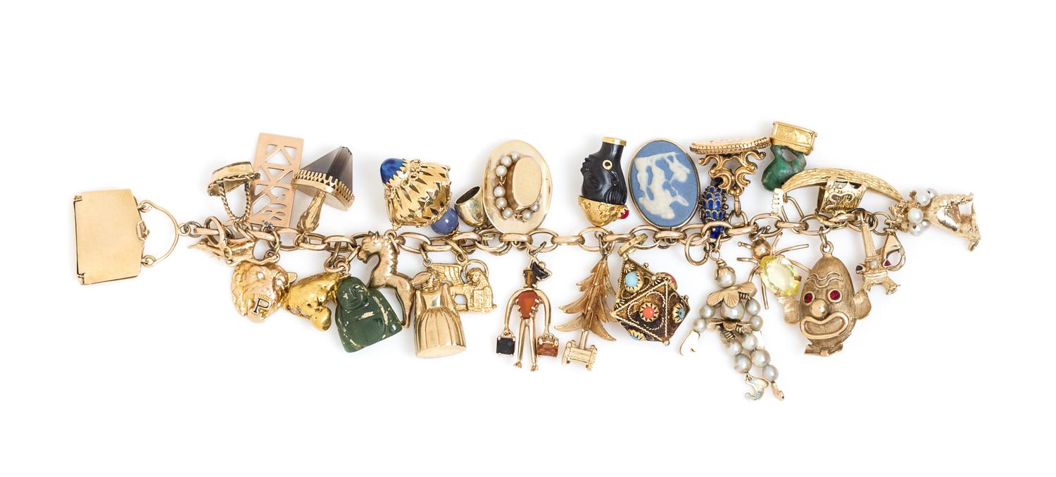 A Yellow Gold Charm Bracelet with 28 Attached Charms, 66.50 dwts.